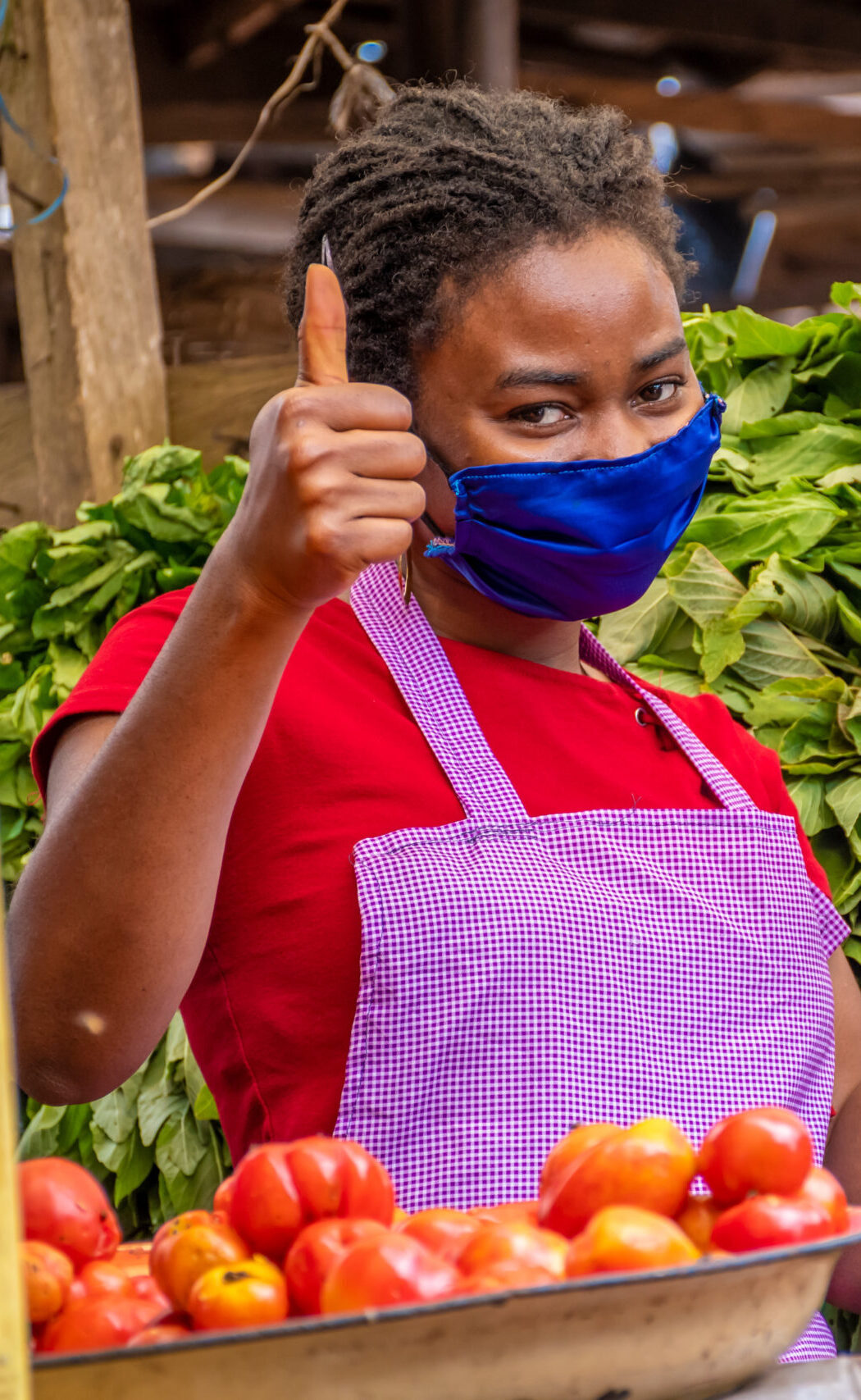 shallow focus woman with facemask holding pos machine market scaled e1771246260635